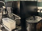 a black coffee maker sitting on a counter in a kitchen