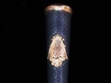 a close up of a metal object with a gold emblem on it