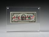 une photo d'un billet de banque dans une boîte transparente