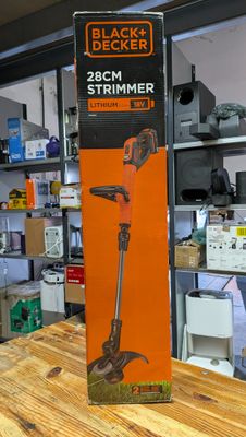 a black and decker electric corded string trimer on a table