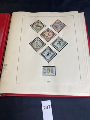a red book with stamps on it on a table