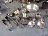 a table with a lot of silver items on it