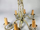 a chandelier that has five candles on each of it