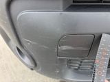 a close up of a person holding a ruler near a car