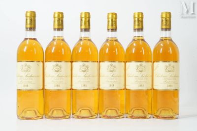 six bottles of wine are lined up on a white surface