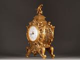 a gold clock sitting on top of a table
