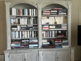 a large bookshelf in the middle of a living room with a flat screen tv