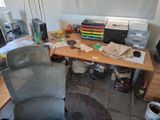 a desk with a chair and a computer on it