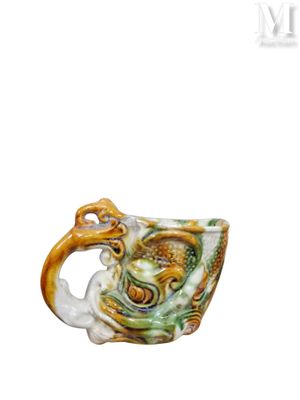 a cup with a dragon on it sitting on a table