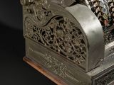 a silver cash register sitting on top of a black table