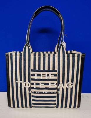 a blue and white striped tote bag sitting on top of a table