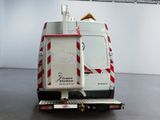 a white truck with a red and white stripe on the back