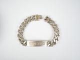 a close up of a silver bracelet with a chain on it