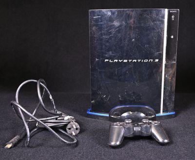 a video game console with a game controller next to it