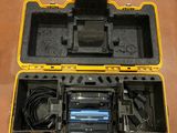 an open tool case with a battery and charger inside