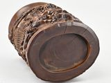 a close up of a wooden object on a white surface