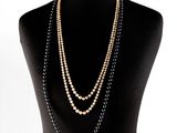 black and gold beaded necklace on a mannequin torso