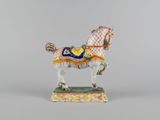 a figurine of a horse with a saddle on it ' s back
