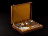a wooden box with silverware in it on a black surface