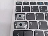 a close up of a laptop keyboard with a small button on it
