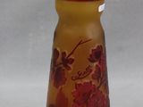 a small glass vase with a floral design on it