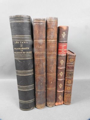 several old books are stacked on top of each other on a table