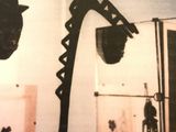 an old photo of a man in a hat and a fireman ' s hat hanging on a wall