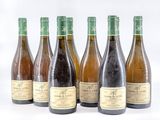 six bottles of wine sitting next to each other on a white surface