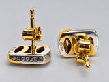 two pairs of gold and silver earrings with a cross on them