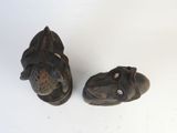 two small wooden animals that are sitting on a table