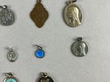 several different types of religious charms are displayed on a white surface