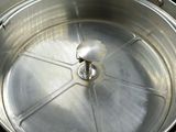 a large metal pot with a metal lid on a stove