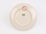 a white plate with a gold ring on it