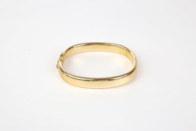 a close up of a gold ring on a white surface