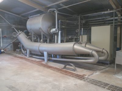 a large metal pipe in the middle of a building