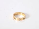 a close up of a gold ring on a white surface