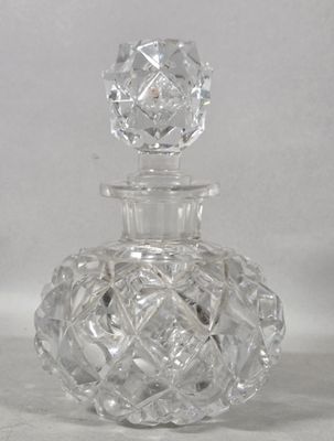 a clear glass bottle with a clear top on a white surface