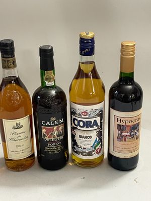 several bottles of wine are lined up on a white surface