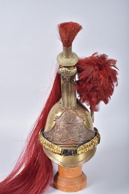 an image of a helmet with a red feather on top of it