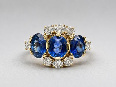 a blue sapphire and diamond three stone ring