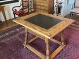 a small table with a black top in the middle of a living room
