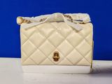 white quilted purse with gold hardware