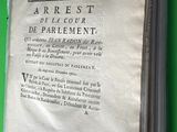 an old book with a green cover on a table