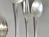 a spoon, fork, and spoon rest on a table