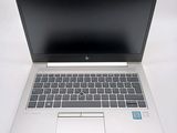 an open laptop computer sitting on top of a white table