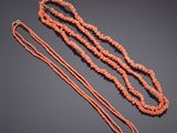 a coral beaded necklace with a gold clasp