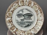 two brown and white plates with designs on them sitting on a table