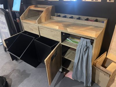 a desk with drawers and bins in a room