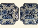 pair of blue and white plates with floral designs on them