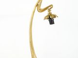 brass plated table lamp with a black glass shade and a brass plated base
